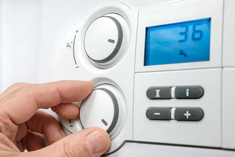 Person turning up the central heating system