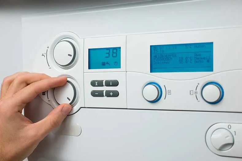 Person adjusting central heating